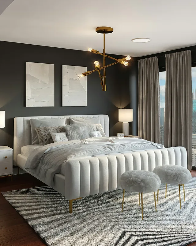 A modern bedroom with a white upholstered bed, gold chandelier, and city view