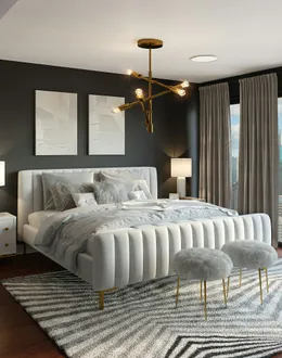 A modern bedroom with a white upholstered bed, gold chandelier, and city view