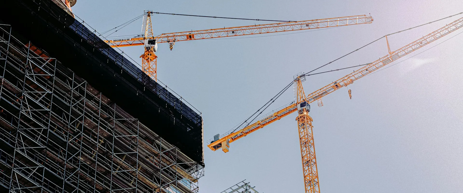 yellow crane near building during daytime