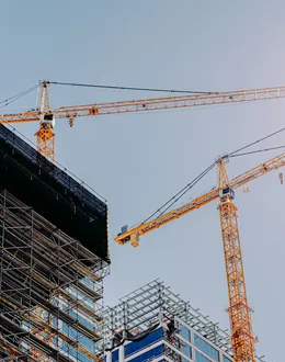 yellow crane near building during daytime