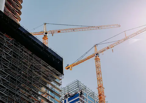 yellow crane near building during daytime