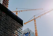 yellow crane near building during daytime
