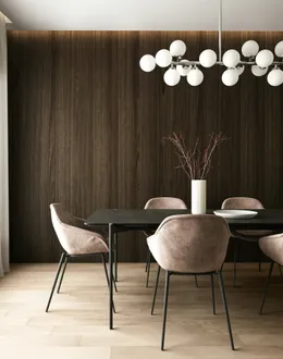 a room with a table chairs and a plant with lights