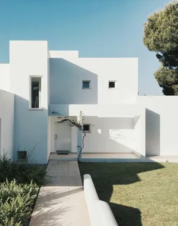 A two story house with a lot of windows and balconies — detail 2