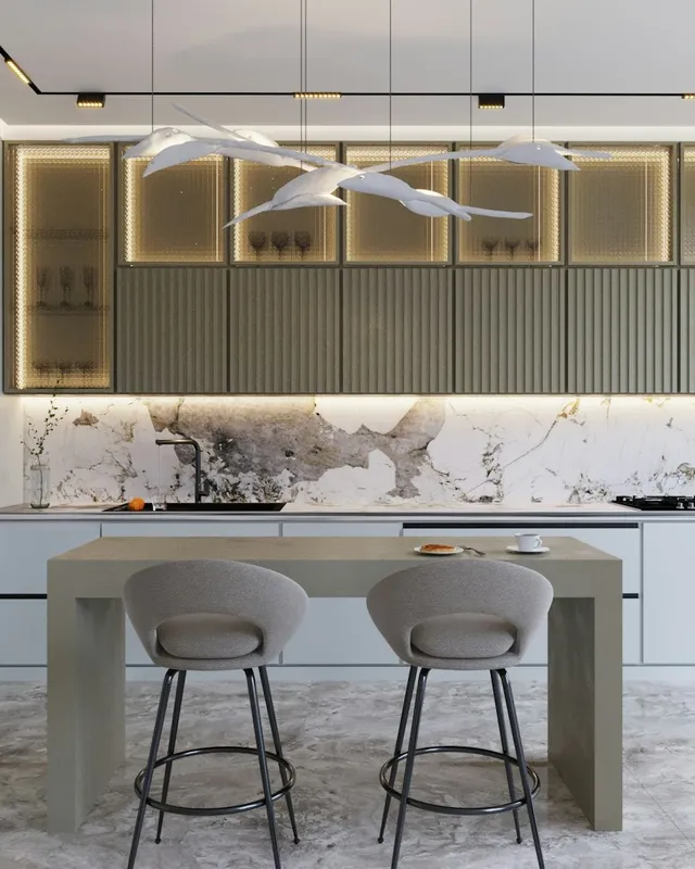 a modern kitchen with marble counter tops and stools