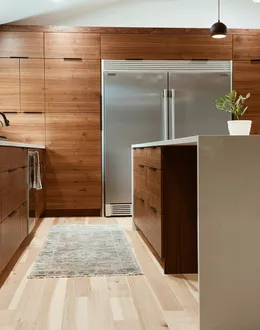 a modern kitchen with marble counter tops and stools — detail 1