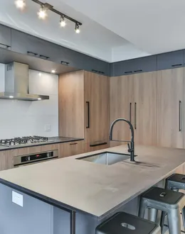 a modern kitchen with marble counter tops and stools — detail 2