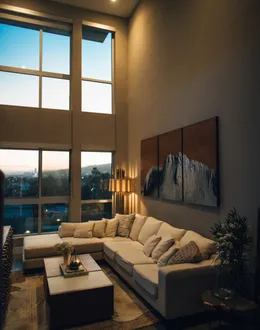 gray padded chaise couch beside window