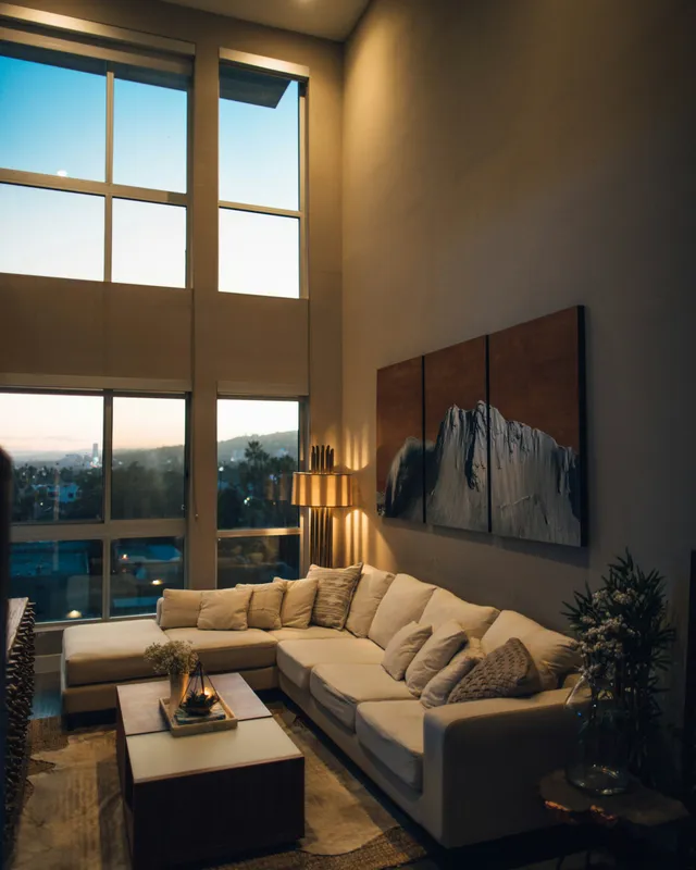 gray padded chaise couch beside window