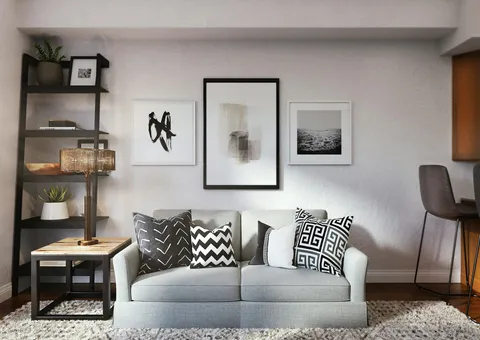 white and black throw pillow on white couch