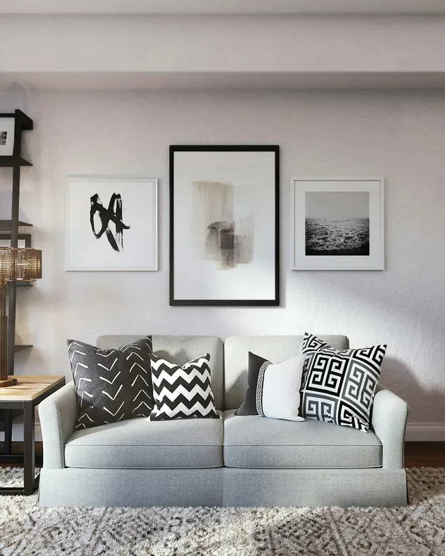 white and black throw pillow on white couch